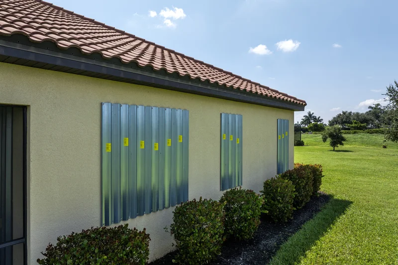 Lawn maintenance showing trimmed shrubs and green grass outside a home